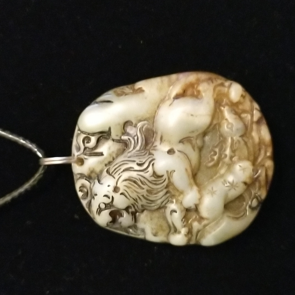 Gorgeous lion carved into a large chunk of natural jade on black choker
